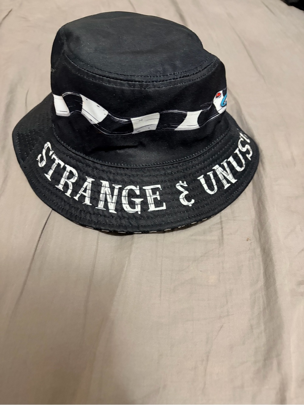 Black 'Strange & Unusual' Graphic Bucket Hat